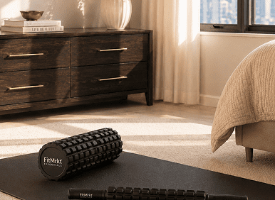 Foam roller and massage stick on yoga mat